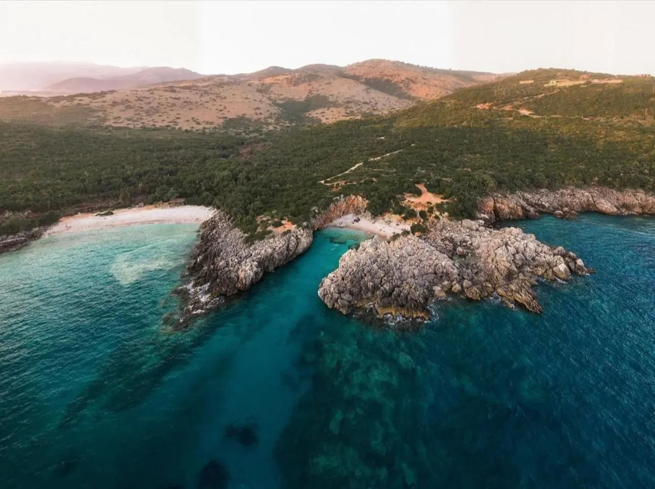 The headland and the bay from the air in low evening light