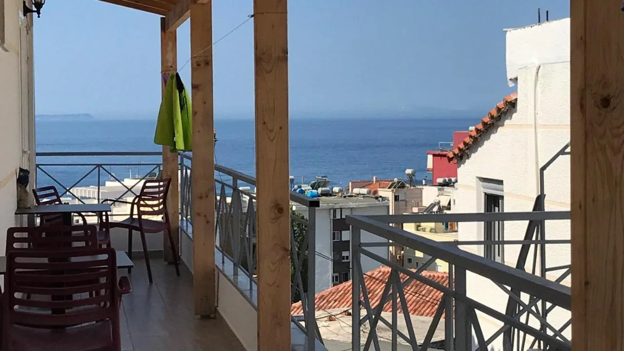 The double studio balcony between timber posts, looking over the town to the sea