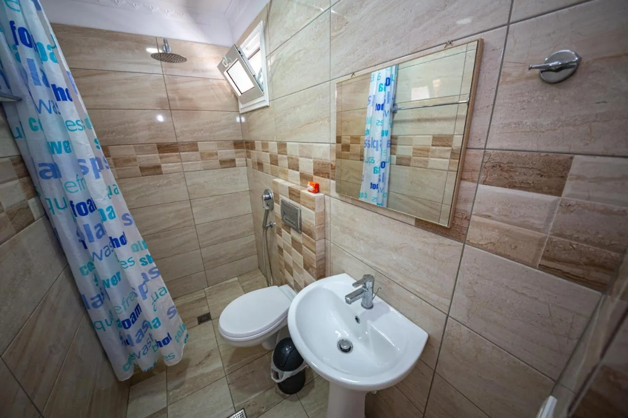 The double studio's shower room with a tiled wall, basin and mirror