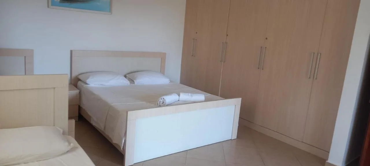The bedroom of the ground-floor apartment with a large double bed and a wide wardrobe