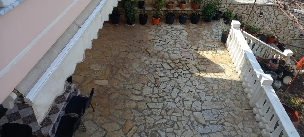 The crazy-paved stone courtyard on the ground floor, with pot plants along the wall
