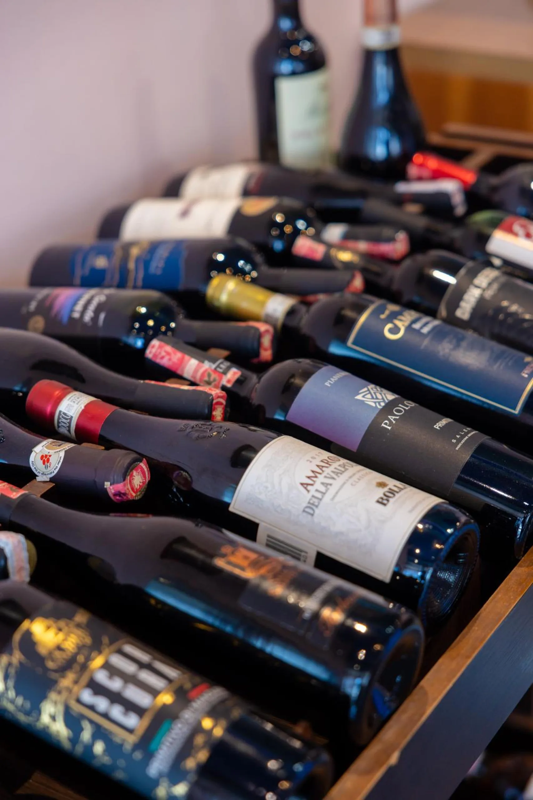 Bottles of wine laid on their sides in a wooden rack
