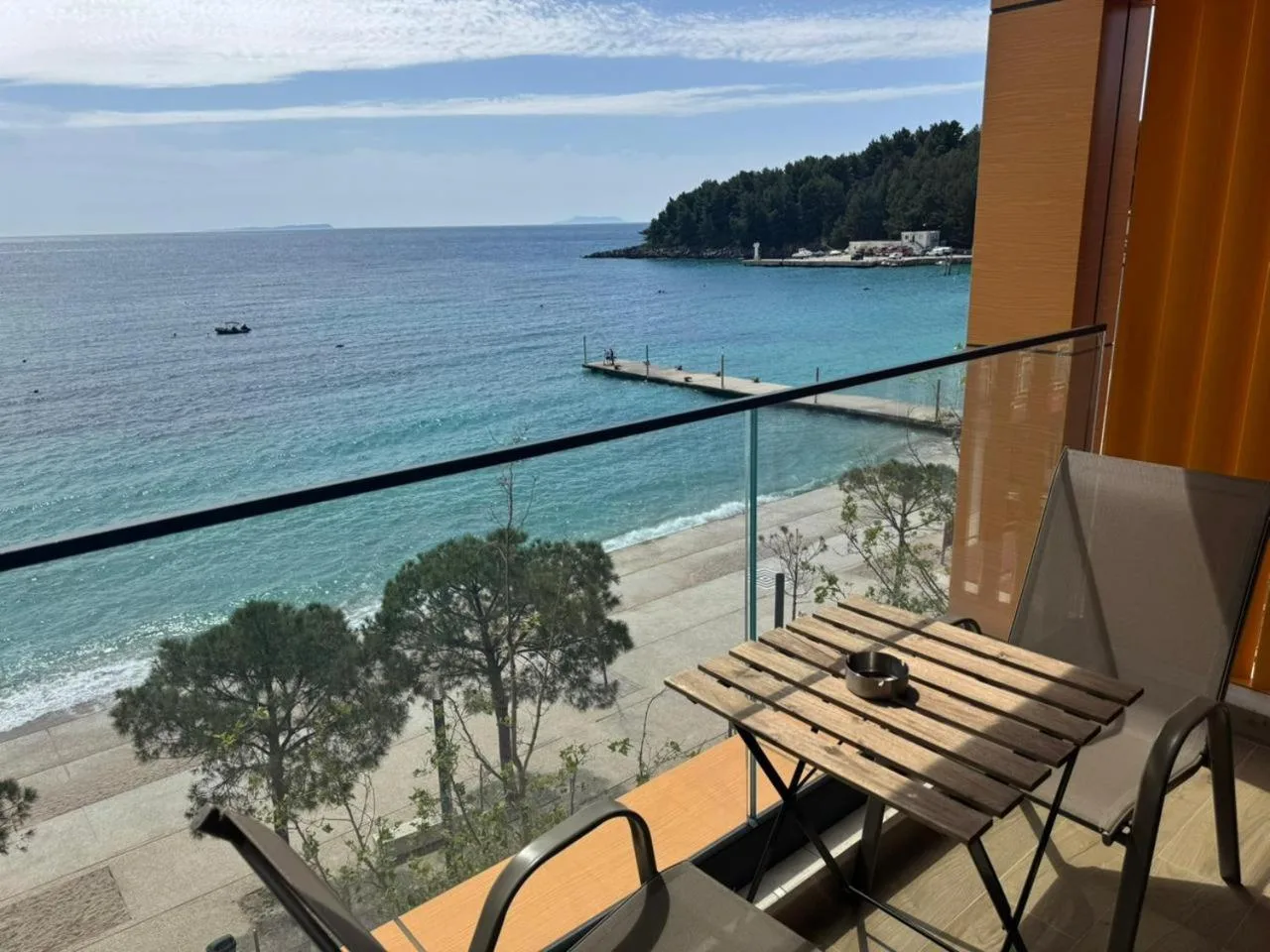 From a sea-view balcony: the beach, the promenade pines and the jetty running out to the pine-covered point