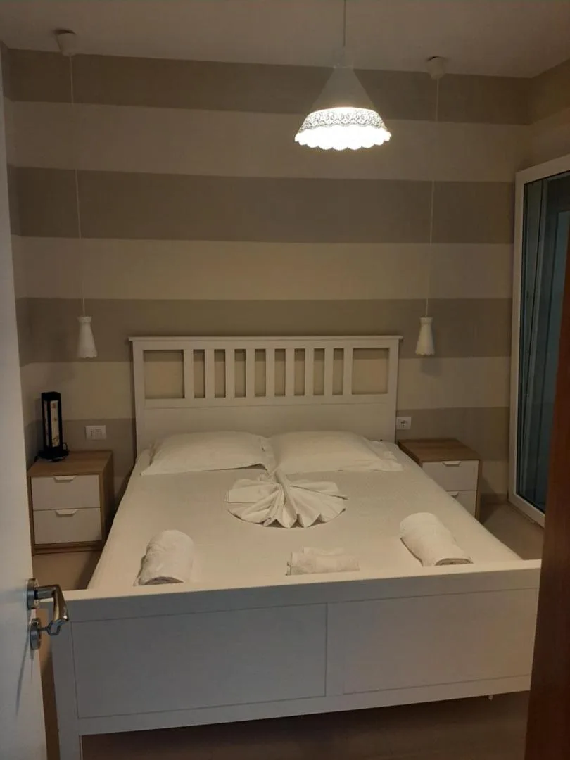 A king-size bed with a white slatted headboard