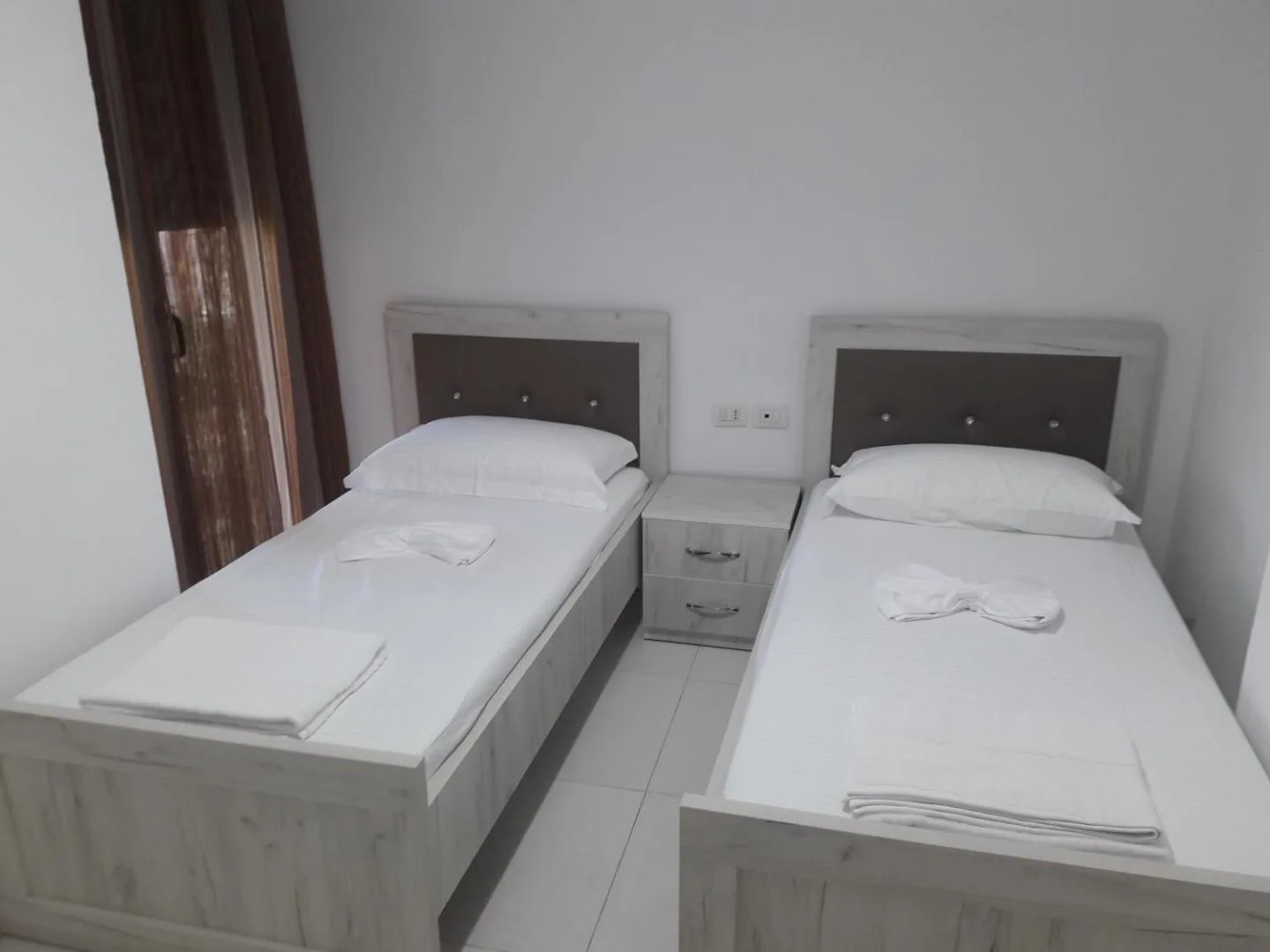 Two single beds side by side in a villa bedroom