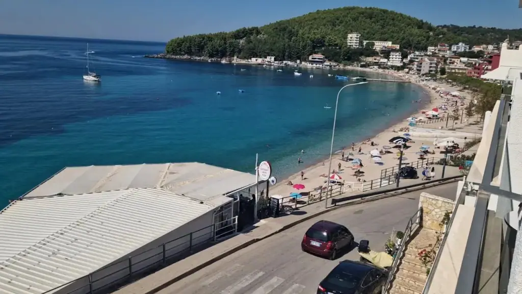 The curve of Spile beach and the seafront road seen from an upper balcony