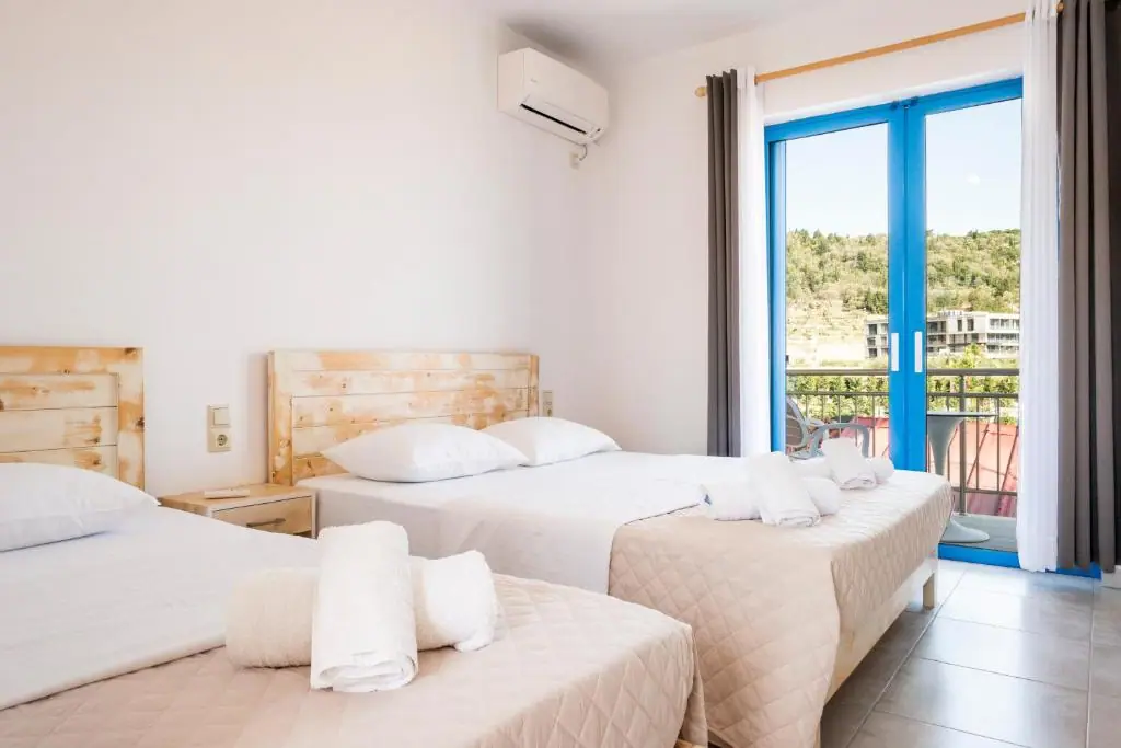 Spacious triple room at Blue Horizon with three beds and a balcony