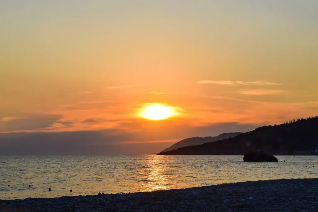 Sunset over the pebbles of Livadhi Beach