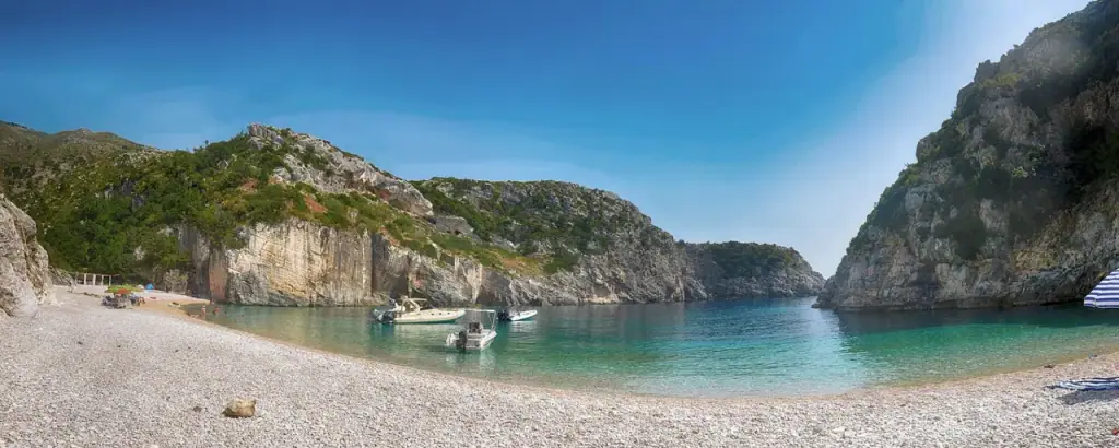 The turquoise cove of Gjipe Beach framed by cliffs