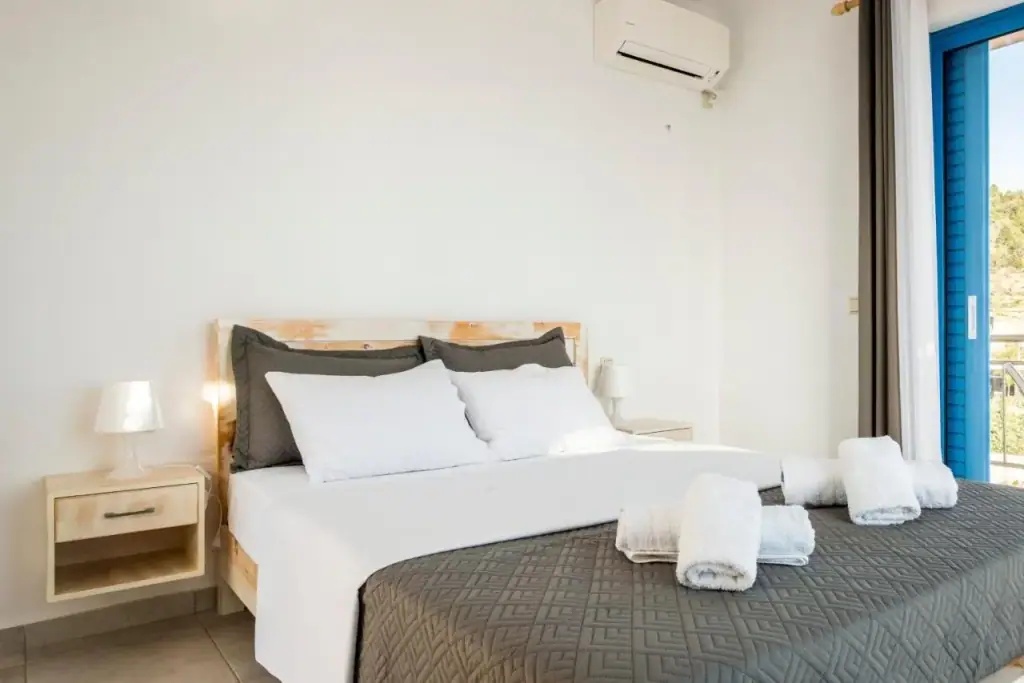 Bright double room at Blue Horizon with wooden bed and balcony