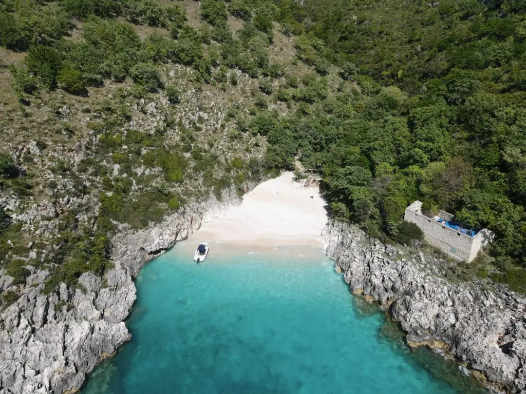 A small turquoise cove with a boat on the southern Albanian coast near Saranda