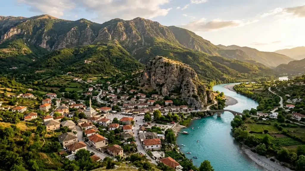 The Vjosa river curving past the town of Përmet below green mountains in southern Albania