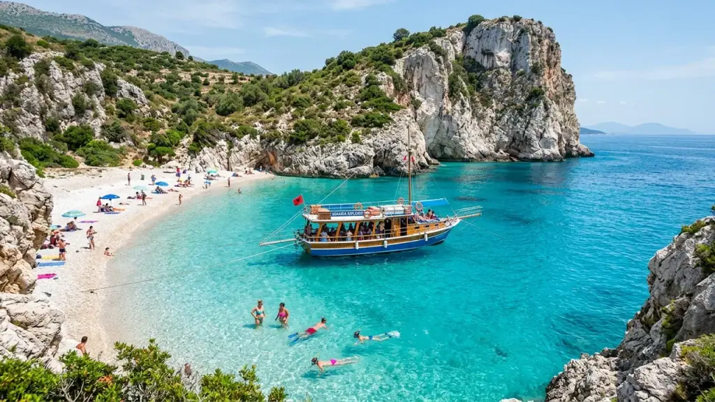 Tour boats anchored in a turquoise bay near Saranda with limestone cliffs behind