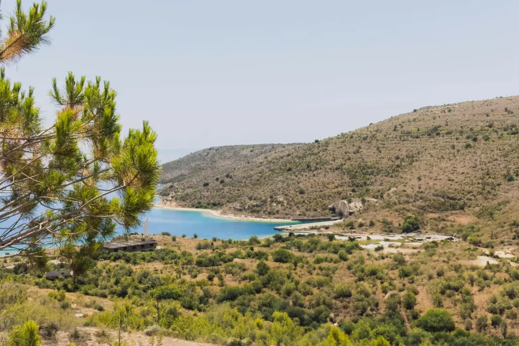 Green hills meeting a quiet turquoise bay on the far southern Albanian coast