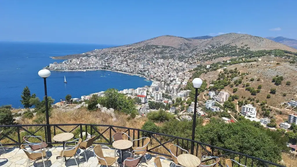 The view from Lëkurësi Castle terrace over Saranda bay, the town curving around the water with hills beyond