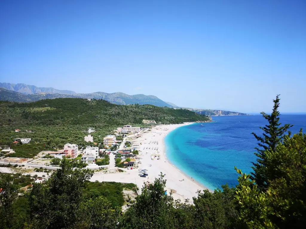 Livadhi Beach stretching 1.5 km with crystal-clear shallow waters framed by rocky headlands