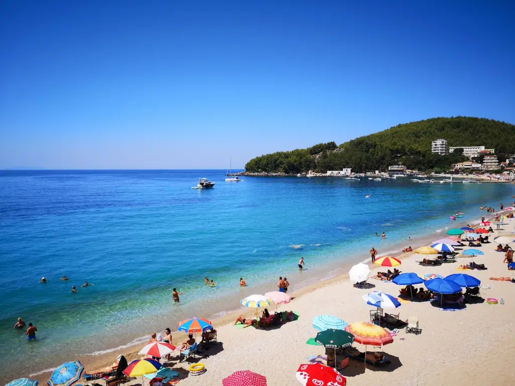 Sfageio Beach with turquoise shallow waters beside the Himara pier