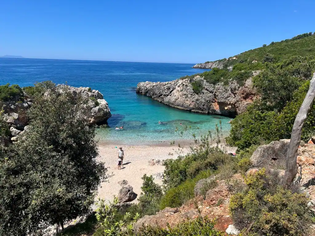 The cove at Akuarium Beach enclosed by its rocky headland
