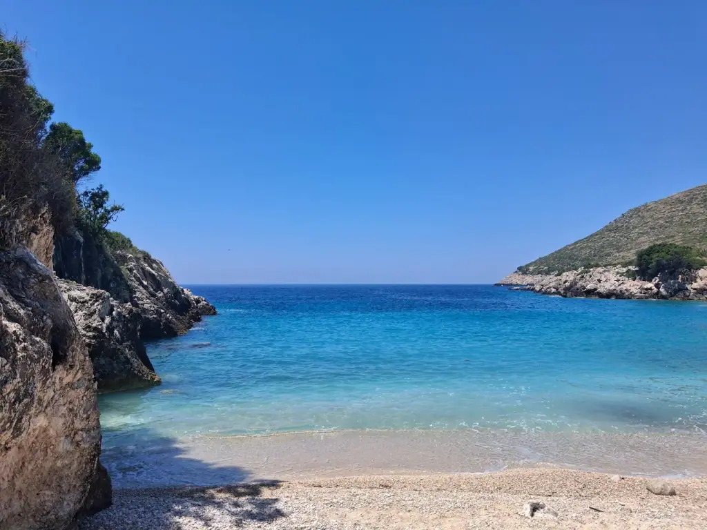 Pebble shore and turquoise shallows at Bear's Bay