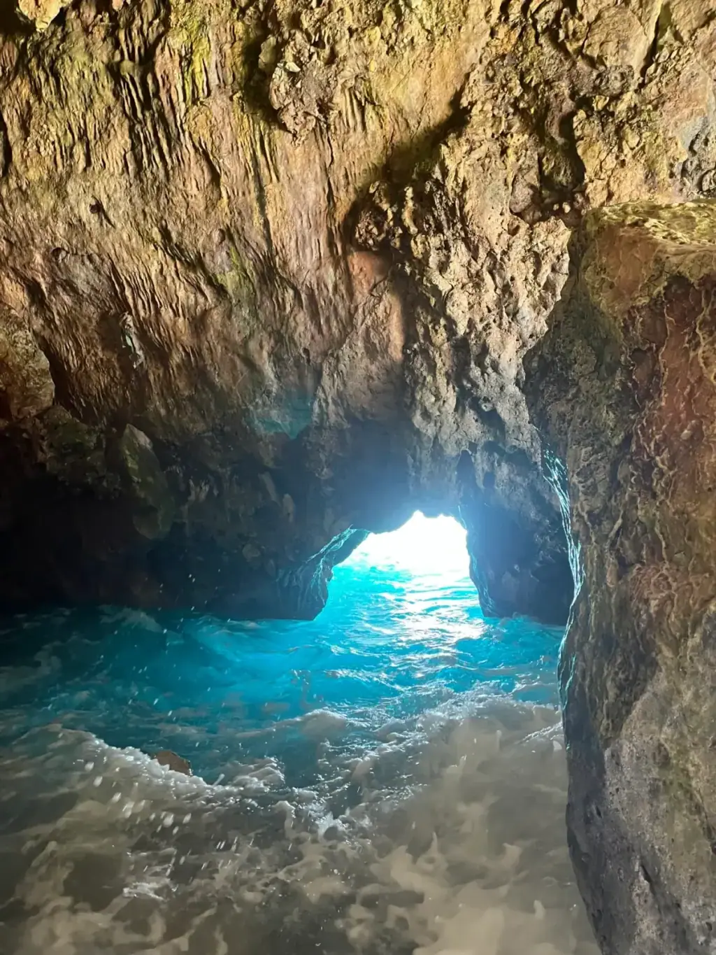 Sea cave on the Albanian Riviera with sunlight piercing the opening, similar to the Blue Cave