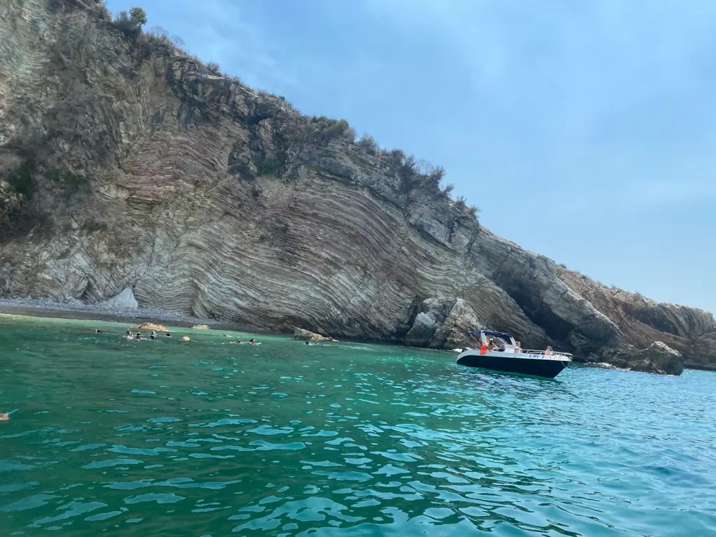 A boat anchored under the cliffs at Cape of Qefali