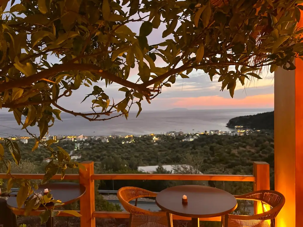 Mirage Cocktail Bar's hillside terrace at dusk, overlooking Himara bay and the Ionian Sea