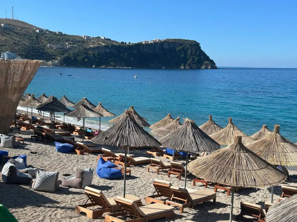 Namos Beach club's sunbeds, bean bags and thatched umbrellas on the Potami cove sand
