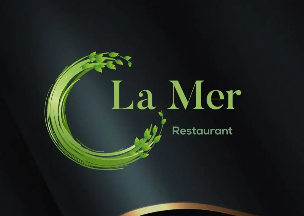 Thatched-roof street terrace and menu board outside LaMer Restaurant in Himara