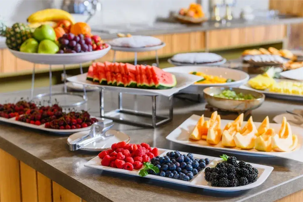 The buffet breakfast at Miamar — cut watermelon, melon, berries, cherries and whole fruit on the service counter
