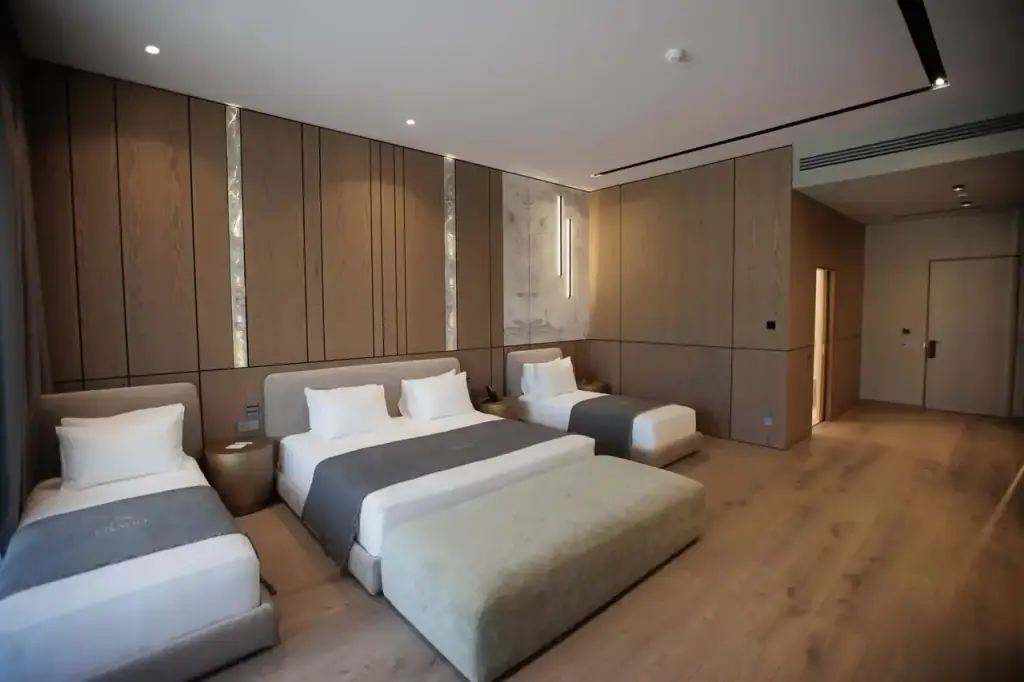 The Family Suite at Prado, a large bed with two single beds alongside it