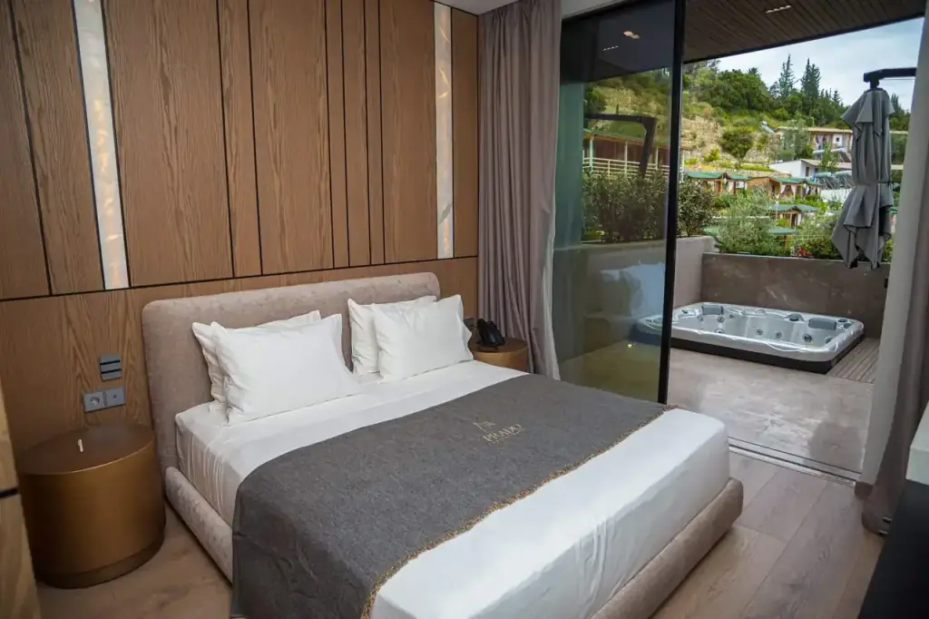 A jacuzzi on the balcony of a Standard Room at Prado, seen from the bed, with the hills beyond