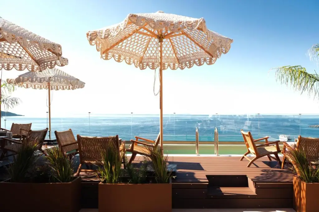 Crocheted parasols and rattan chairs on the roof terrace above the bay