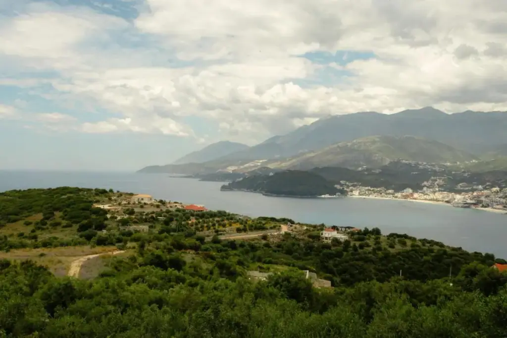 A daytime panorama from the property over the wooded headland, Himarë bay and the coastal mountains