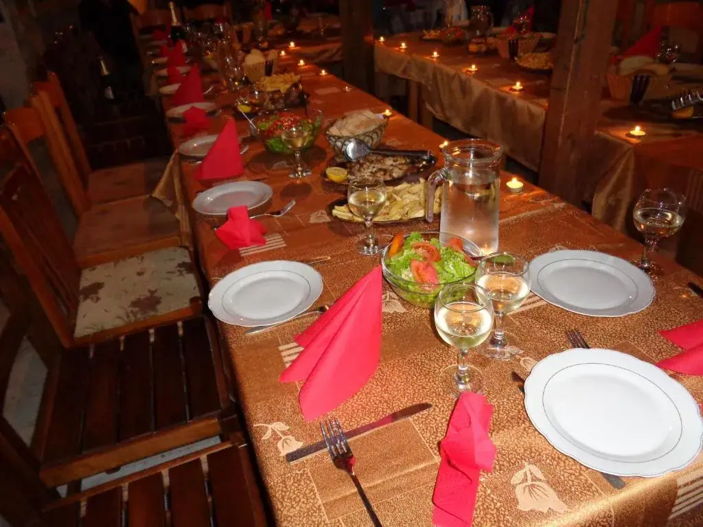 Long tables laid with candles and dishes in Taverna Velco on the ground floor
