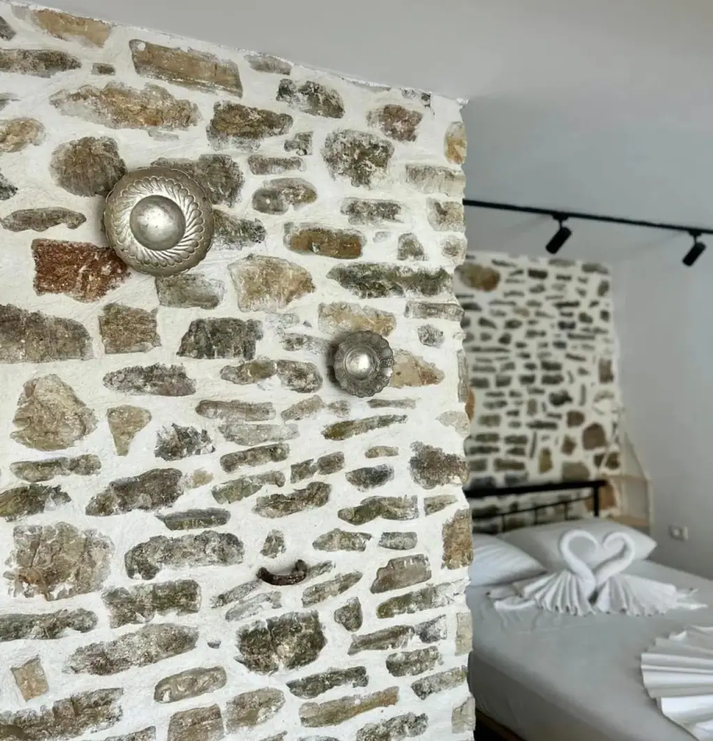 Silver bosses set into the original stone wall of the old house