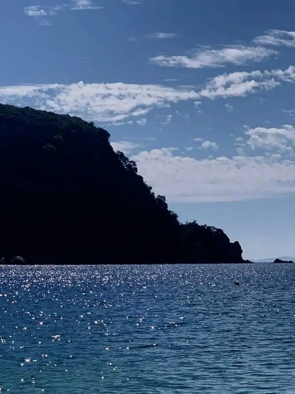 The Ionian sea and the dark headland at the edge of Potami bay
