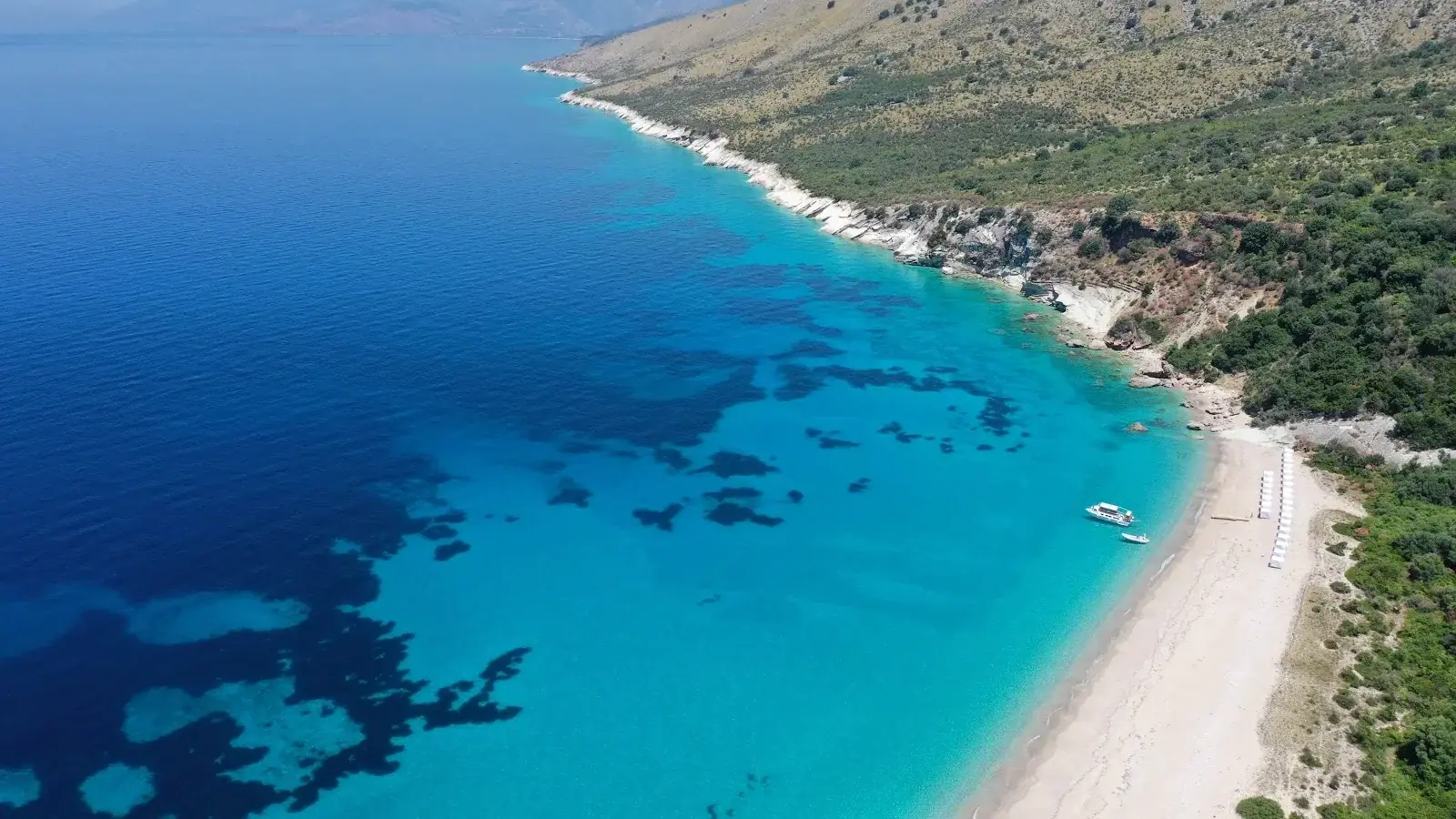 Beachfront hotel zone in Himara at sunset