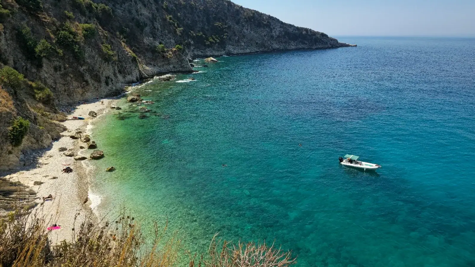 Filikuri Beach hidden cove with turquoise water and steep cliffs