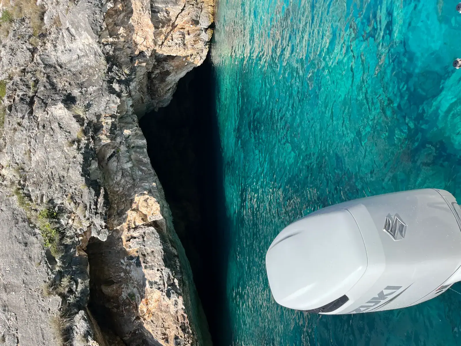 Aerial view of Gjipe Beach with turquoise water surrounded by dramatic canyon cliffs