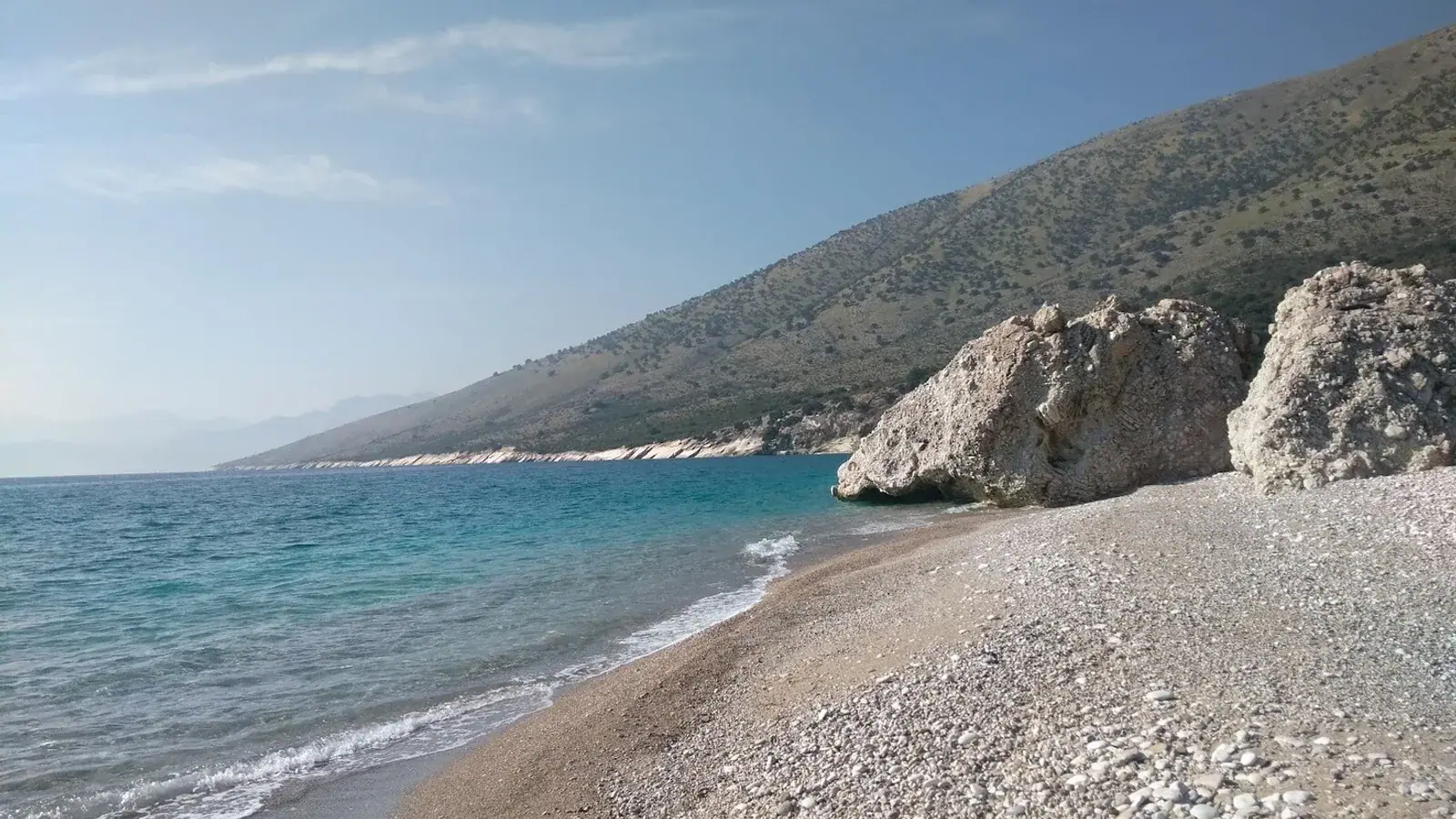 Sunset view of a calm shallow beach near Himara ideal for families with children