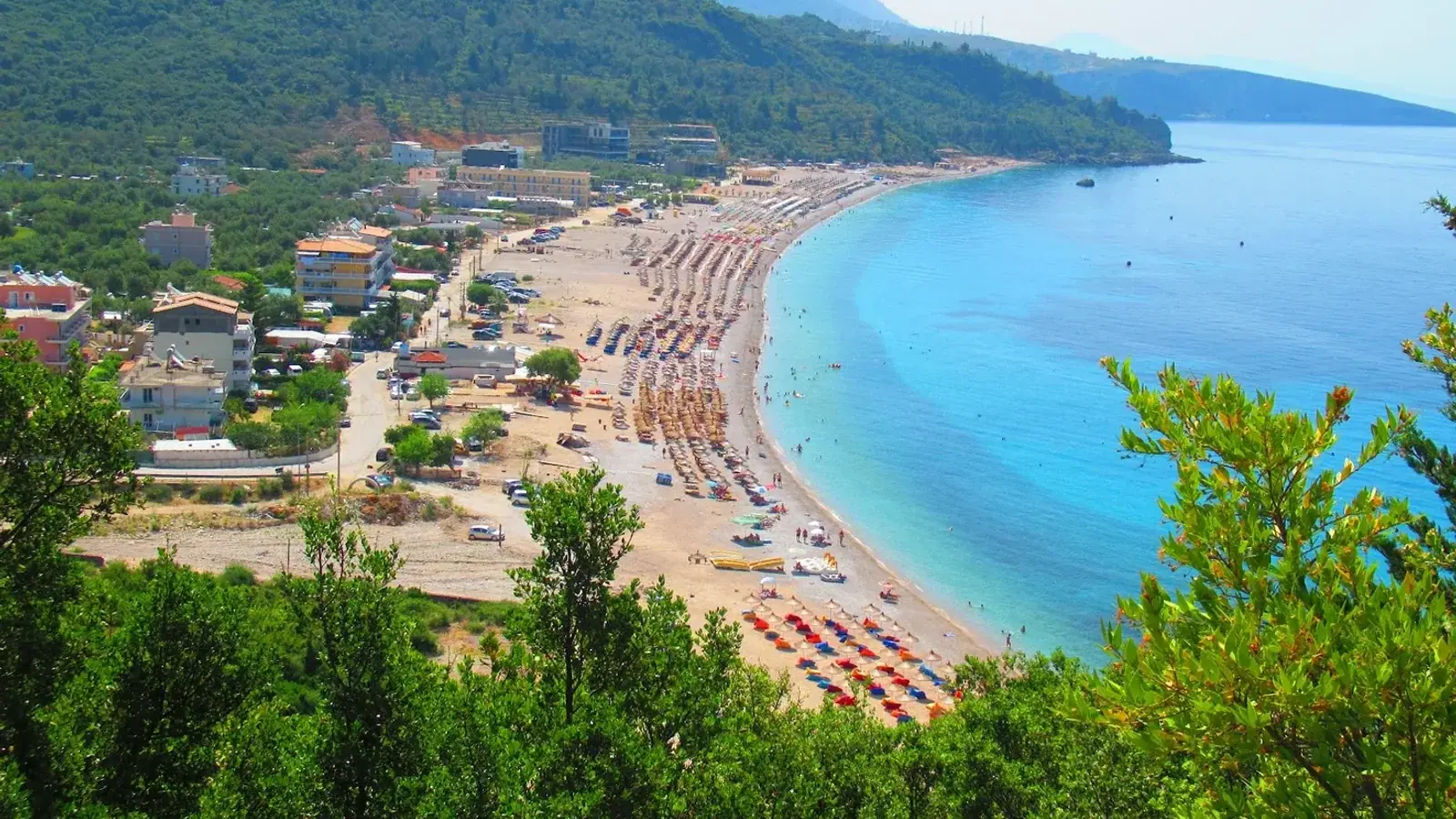 Himara Blue Experience boat on clear turquoise water off the Himara coast, Albanian Riviera