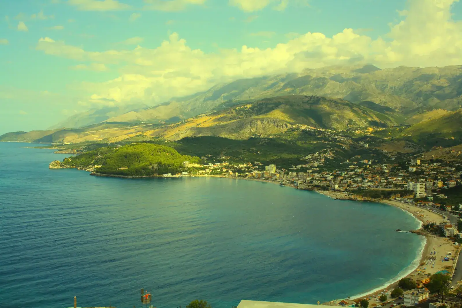 Panoramic view of Himara bay and town in May 2026, current state of construction, openings and the coastline