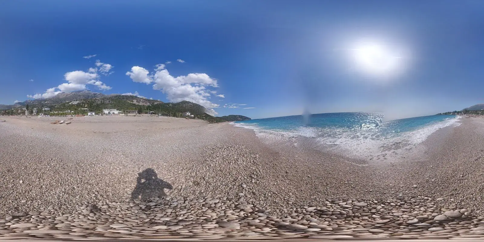 Dhermi Beach panorama with mountains behind