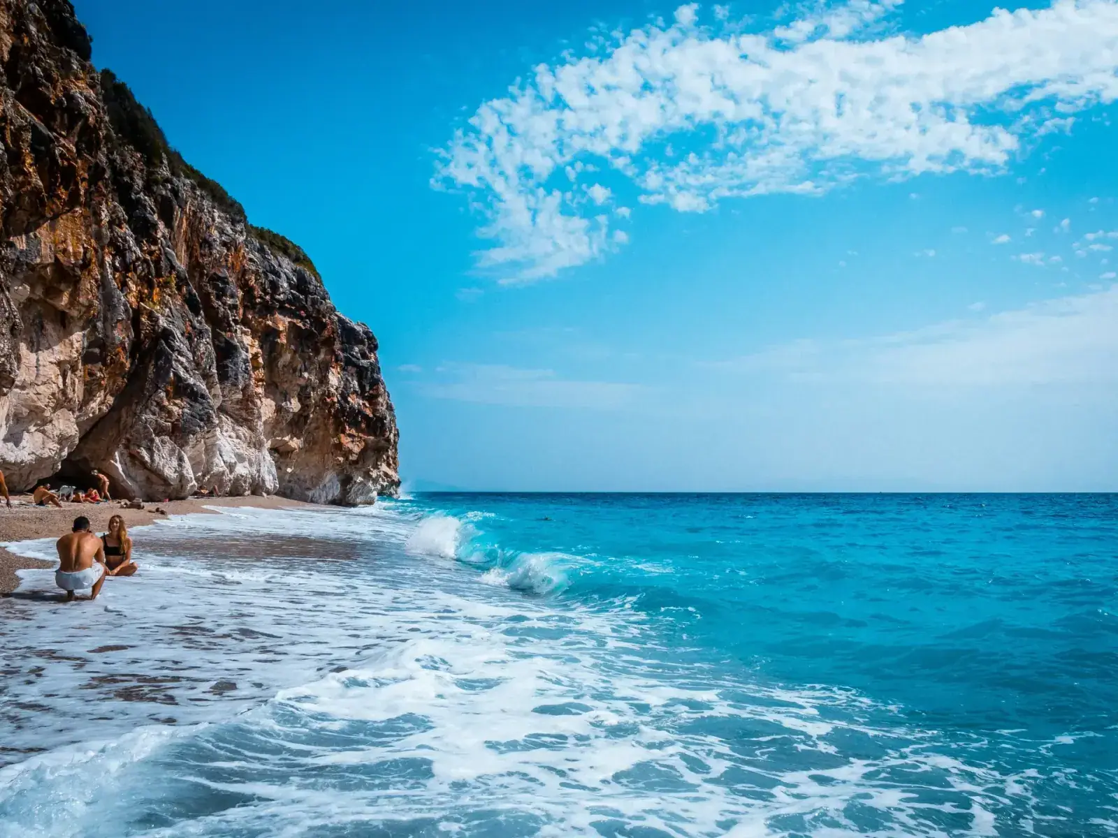 Gjipe Beach with dramatic cliff walls and clear blue water