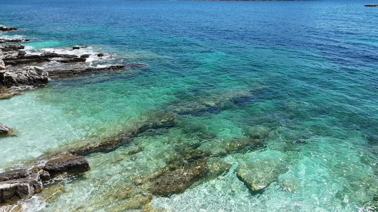 Palermo Beach clear turquoise water over rocks in the sheltered Porto Palermo bay south of Himara