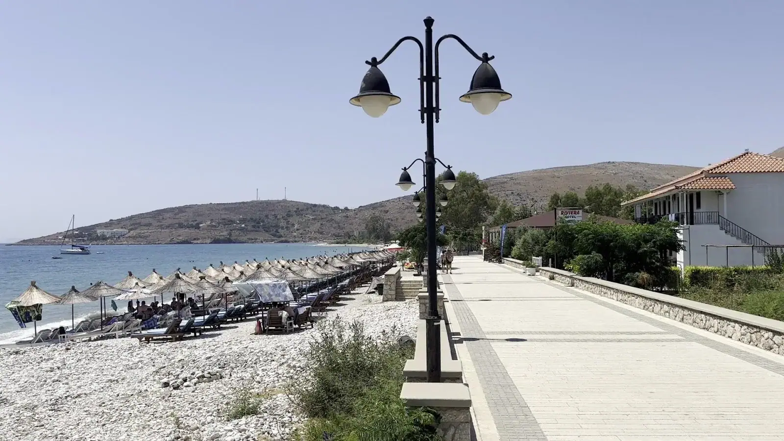 The stone promenade behind Qeparo Beach with its old-style lanterns