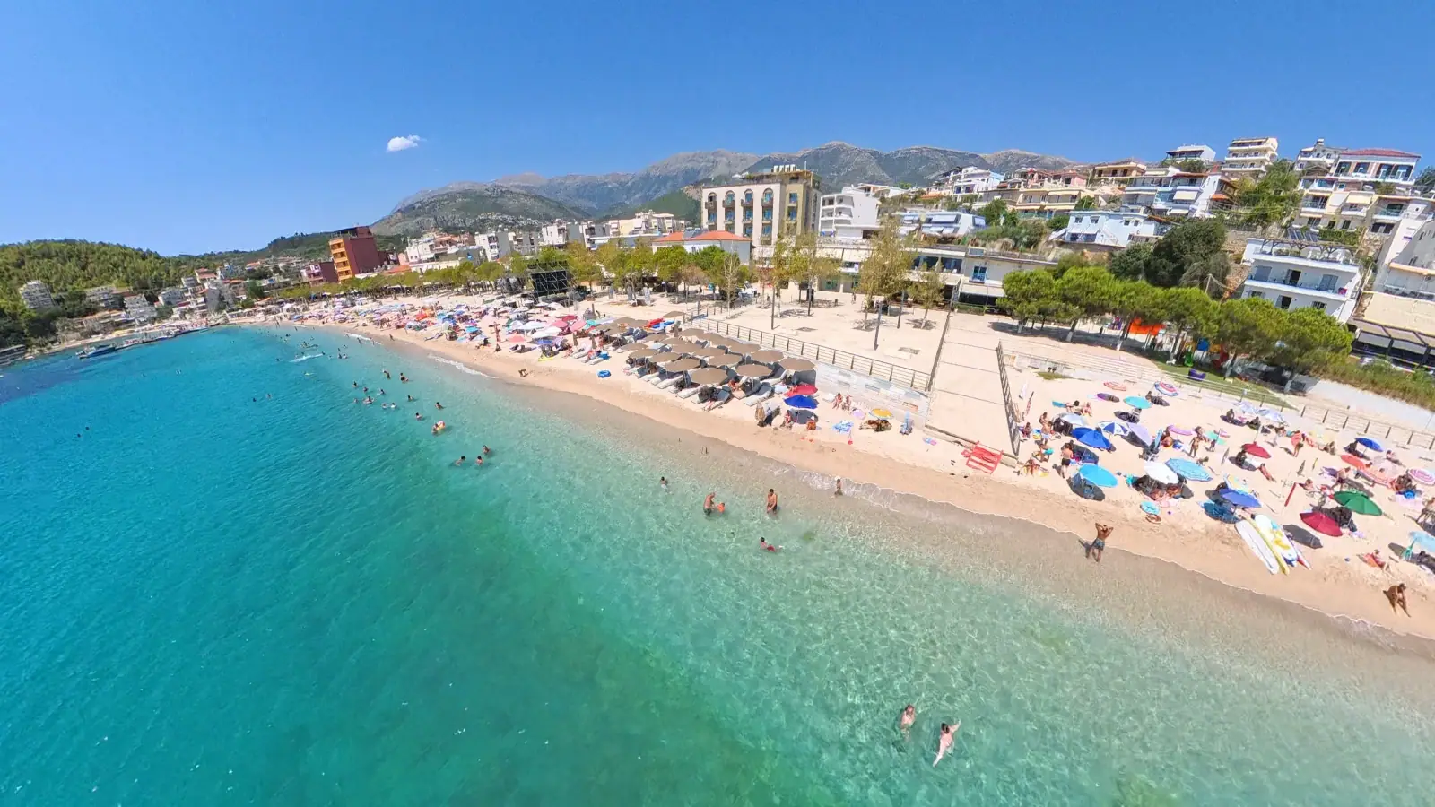 Aerial view of Spile Beach and the Himara promenade with the mountains behind