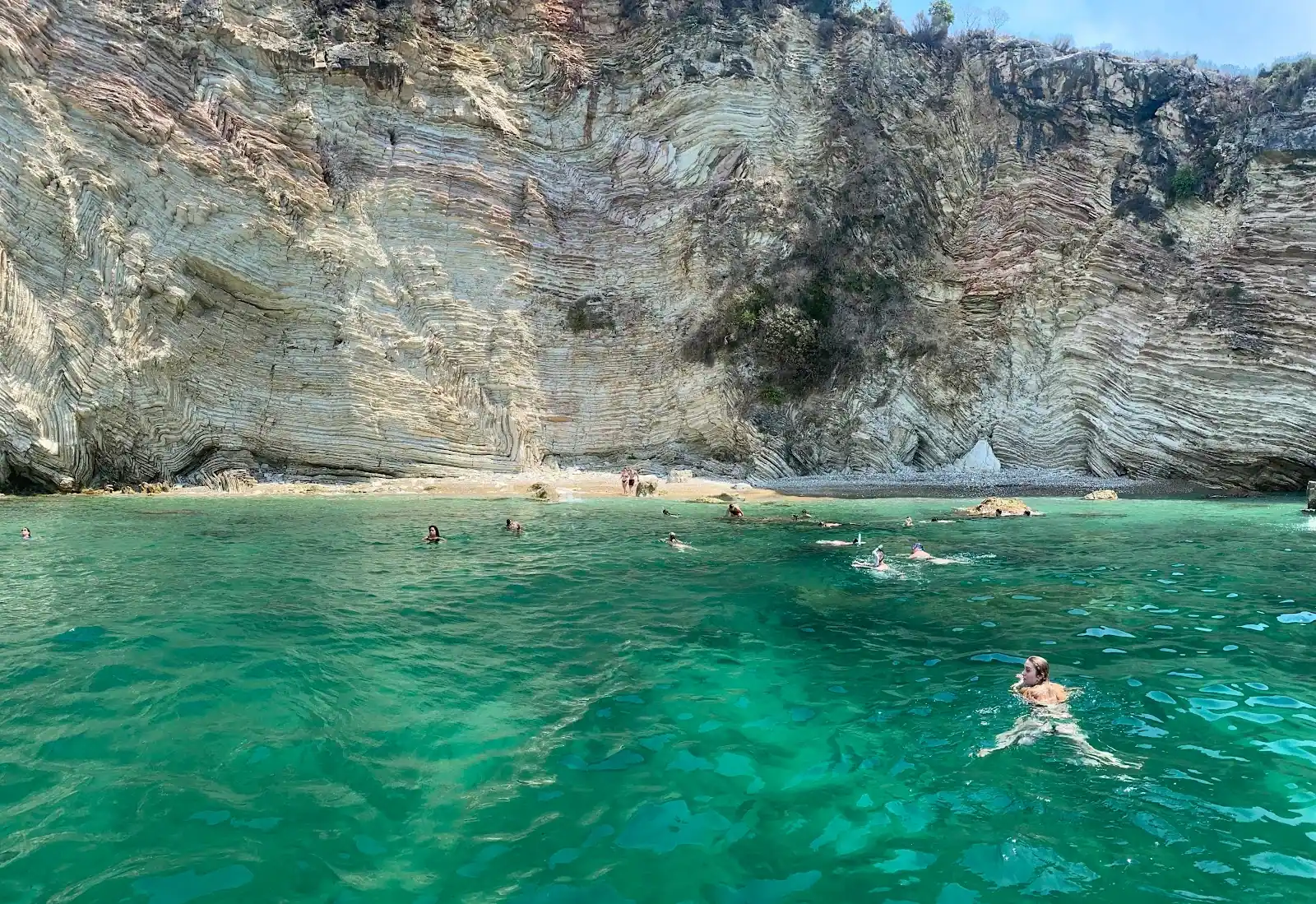 Emerald water below the cliff face at Cape of Qefali