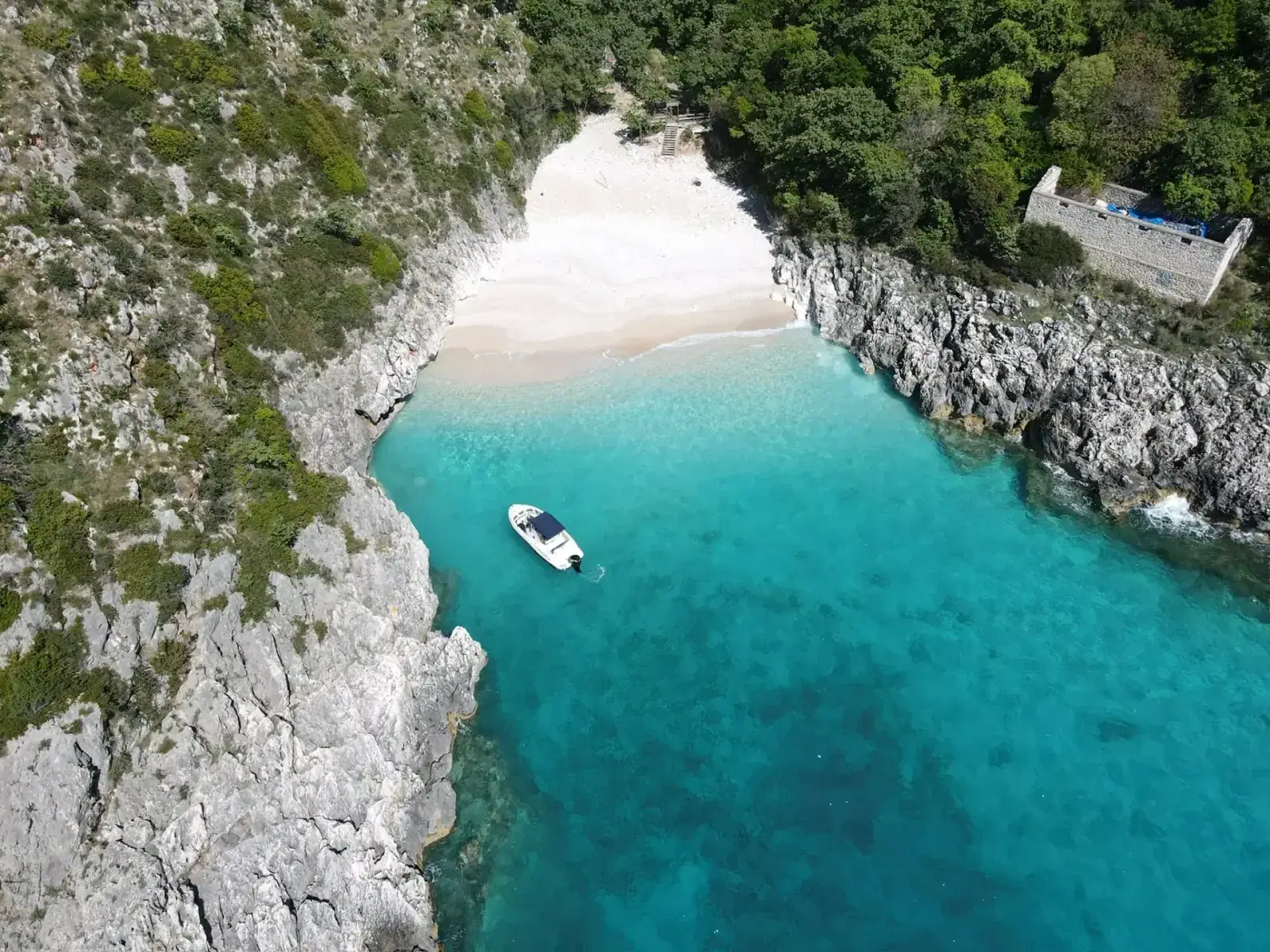 Aerial view of Saint Andrew's Bay with a boat anchored in the secluded cove