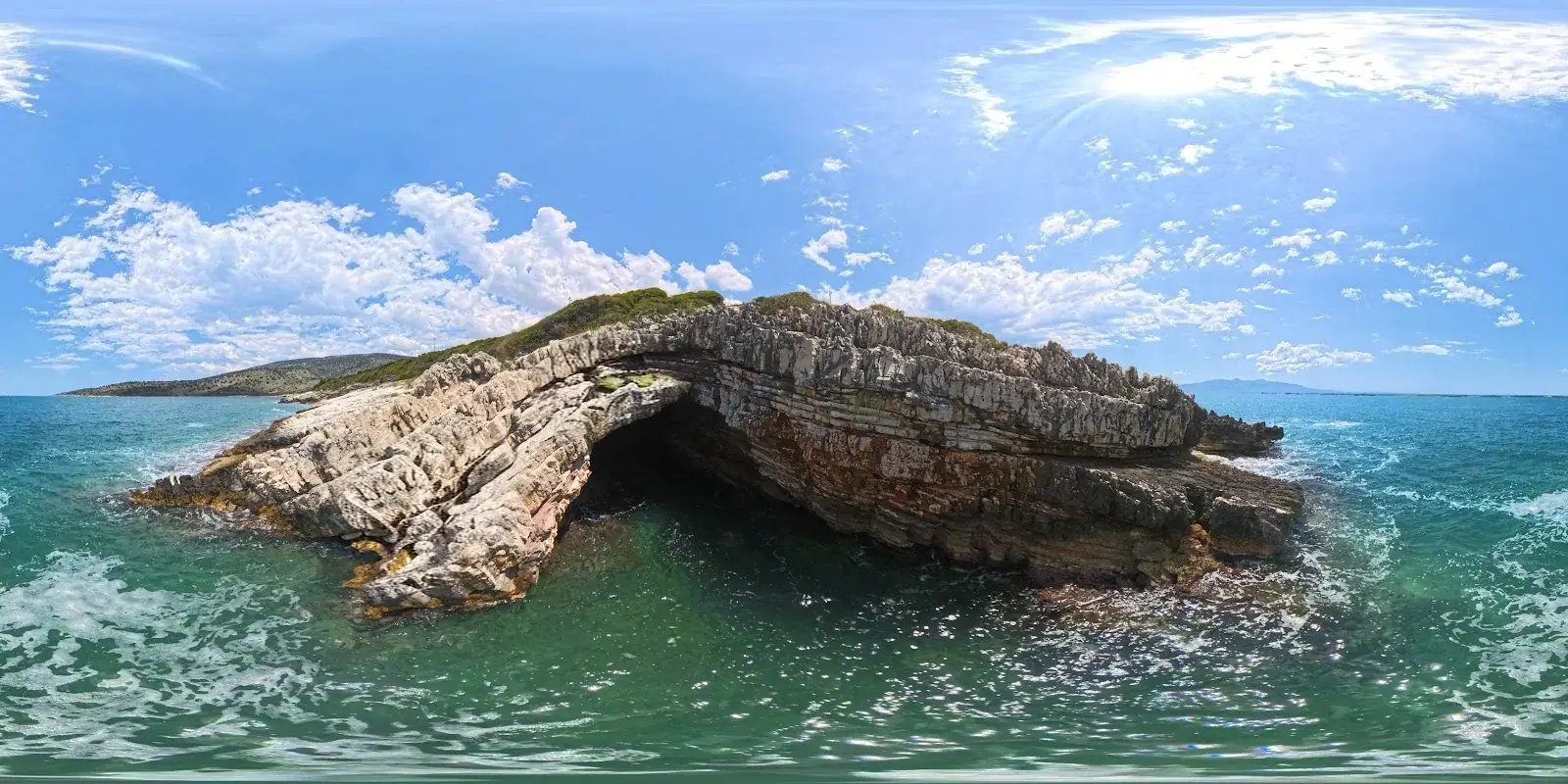 Rock arch over green water at Turtle's Cave
